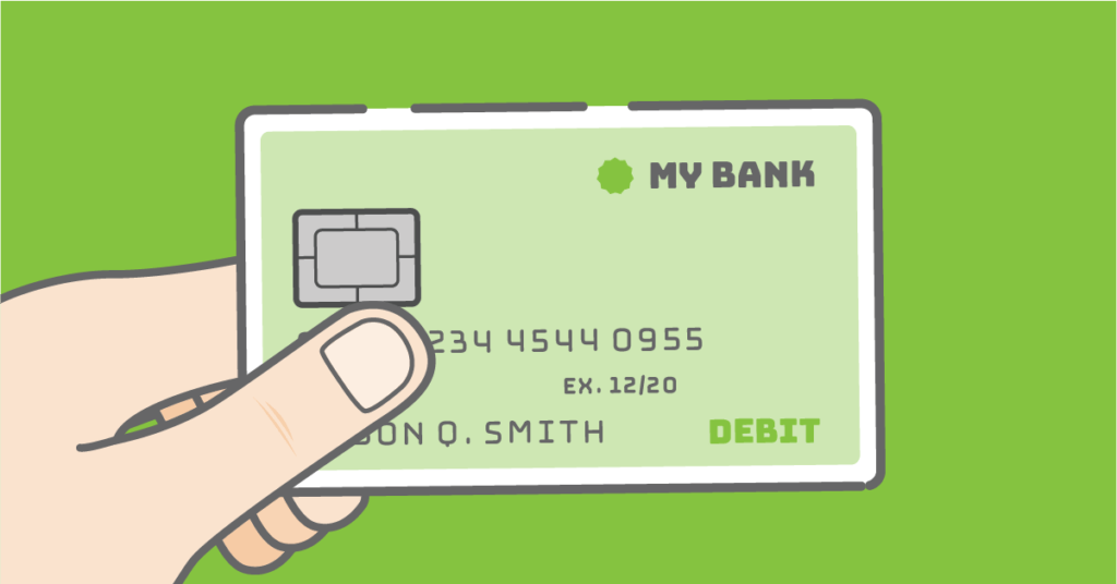 Hand holding a debit card over a green background