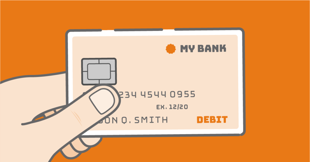 Hand holding debit card over orange background