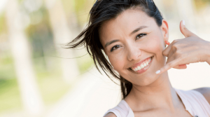 Young woman gesturing to make a phone call