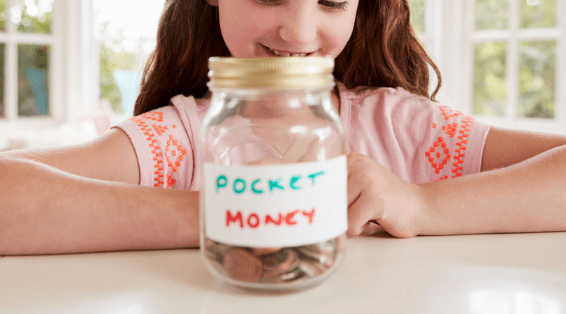 Girl looking at jar of coins labeled "pocket money"
